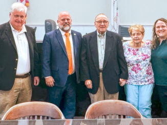 From left to right: Councilor Michael Mintz, Mayor Keith Misciagna, honored volunteer Thomas Madru, his wife, Ellen, and his daughter, Meghan, stand for cameras and cheers following the ceremony honoring Madru’s four decades of volunteer service. Madru continues to serve on the local and county library boards. Photo courtesy Maggie Giandomenico.