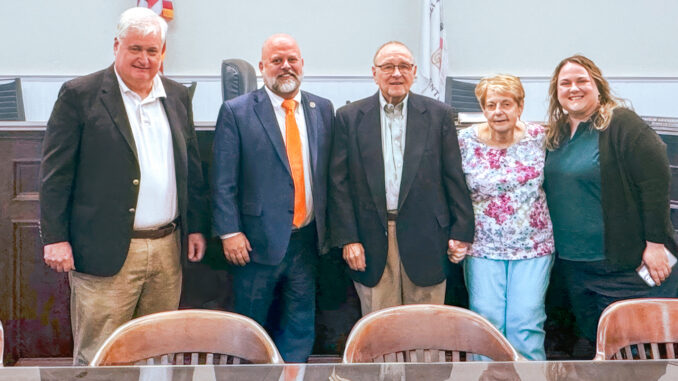 From left to right: Councilor Michael Mintz, Mayor Keith Misciagna, honored volunteer Thomas Madru, his wife, Ellen, and his daughter, Meghan, stand for cameras and cheers following the ceremony honoring Madru’s four decades of volunteer service. Madru continues to serve on the local and county library boards. Photo courtesy Maggie Giandomenico.