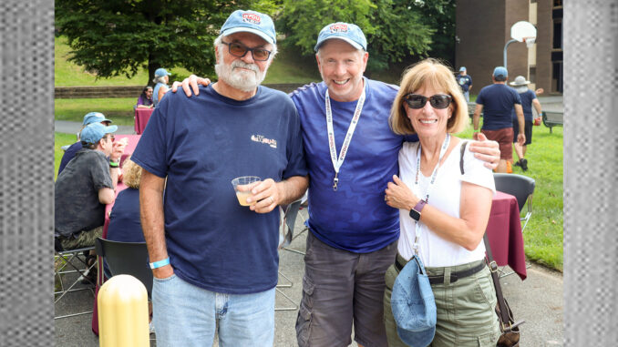 WFDU-FM DJ Jack Pignatello, host of Road Trip Radio and Let's Get Lost, talks with WFDU listeners Mike Olohan, and his wife, Kathe, who attended the Aug. 11 radio station fundraiser that featured BBQ favorites, music, and celebratory WFDU baseball caps. The event ran from 2 to 5 p.m. at FDU's Teaneck campus. Courtesy: WFDU Facebook.