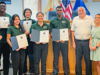 Interns from PSEG's Institute for Sustainable Studies Green Team, in partnership with Montclair State University, are thanked after their July 30 presentation on a flood mitigation study of the Township of Washington’s stretch of Musquapsink Brook. Left to right: Project manager Sara Reper, Montclair State University; Terrell Osei-Kyei, The College of New Jersey; Cayla Capistrano, Rutgers University; Emily Pazuello, Montclair State University; MeiLi Han, Hofstra University; Vinlaw Mudehwe, Case Western Reserve University; Councilman Tom Sears; councilwoman Daisy Velez; and council vice president Steven Cascio. Photo credit: Susan Witkowski.