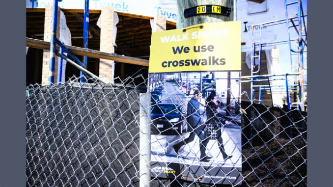 Signs warn pedestrians near the stalled Emerson Station redevelopment project in April 2024. John Snyder photo