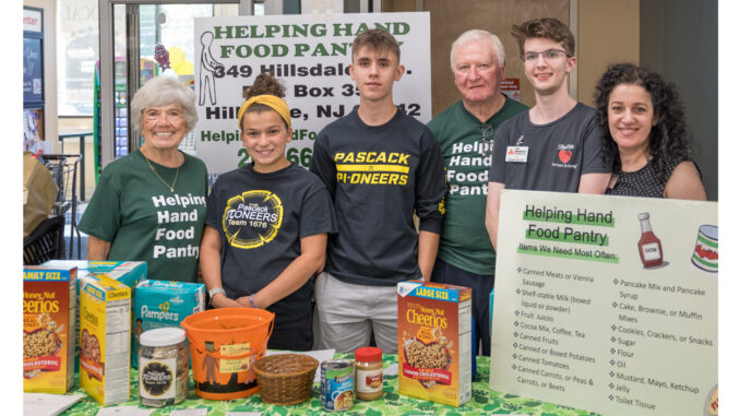 FIRST Team 1676 Pascack Pi-oneers power Inserra Supermarkets ShopRite of Hillsdale’s Partners in Caring project on Sept. 22. Above, left to right: Lois Kohan, Abby Guggino, Victor Urumov, Roy Kohan, and ShopRite’s Jack Callaghan and Zamira Lata. John Snyder photo.