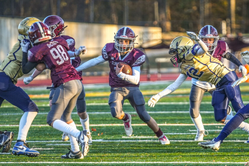 Dual threat RV QB Ryan McTigue (#30) runs between blockers and tacklers for a first down on Nov. 23, 2024. Mike Smith photo.