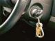 Shot of Car key and house key dangling from the ignition of car