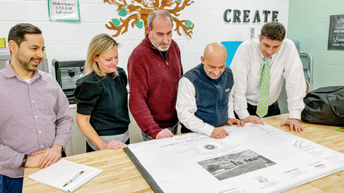 New Hillsdale Public Schools trustee Kathleen Puerta joins, from left to right, Michael Kenduck, Salvatore Sileo, Justin Saxon, and Kevin Donatello in looking over George White school overhaul plans on Feb. 10. Photo: Mike Olohan.