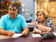 In this file photo from Tuesday, June 25, 2024 at Jack Woods Senior Center, residents Michael DeSena and Maryann Ozment review materials at the heart of an early phase of redevelopment at the former private town swim and rec club site, some 6.1 acres the town has purchased in part with open space funds. John Snyder photo