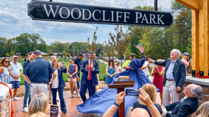 Woodcliff Park feat Woodcliff Lake Mayor Carlos Rendo applauds as the name of the borough’s new park is officially revealed on Saturday, May 3. It is the borough’s first and only municipally owned park. Photo by Mike Olohan