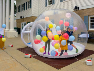 First in the Balloon Globe: Adeline, Tobias, and Gideon Oosting of Hillsdale were the first to test out the new balloon globe. Dave Franz photo.