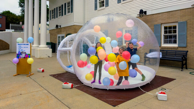 Bubble fun HFPL First in the Balloon Globe: Adeline, Tobias, and Gideon Oosting of Hillsdale were the first to test out the new balloon globe. Dave Franz photo.