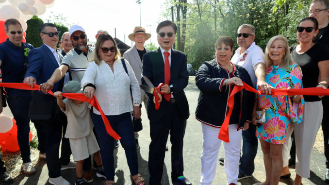 Mayor Mark M. Park is joined at the ribbon-cutting ceremony by councilmembers Tim Koutroubas, Zhi Liang, Rashid Patel, and Rivka Biegacz; Police Chief William Henkelman; members of the police, fire, and public works departments; North New Jersey Chamber of Commerce President Carol Rauscher; and Stephanie Jang, interim director of recreation. Hillary Viders photo.
