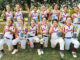 Champions, Together: The winning team—Carly Berube, Sydney Lugo, Emily Briscoe, Aria Reilly, Liana Spadaccini, Hailey Gammarati, Sadie Aday, Lila Waters, Olivia Ribando, Lily Casella, Vivienne Olori, Ellie O’Connell, and Melanie Briscoe—celebrates with coaches Curt Briscoe, Jennifer Briscoe, Ralph Lugo, Mike Gammarati, Greg Waters, Tim O’Connell, and Maria Spadaccini.
