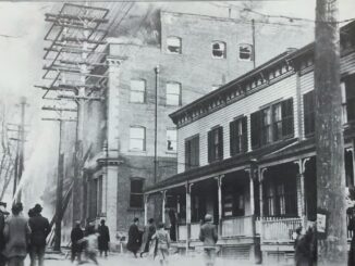 Onlookers fill Bergen Street as firefighters douse flames in the Bergen Building, March 10, 1911.