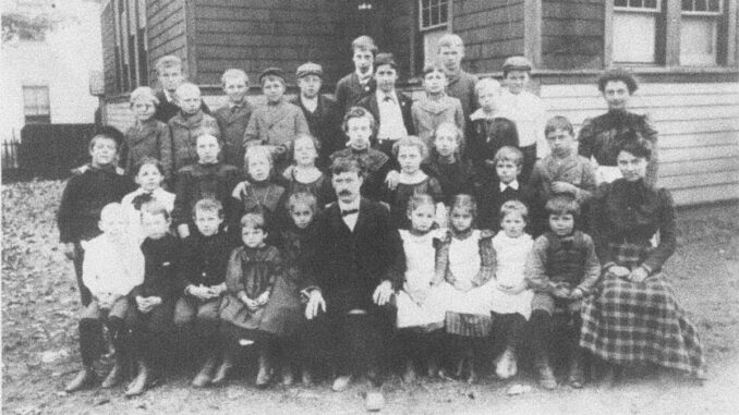 OT wooden schoolhouse Old Tappan's two-room schoolhouse, along with teachers, principal, and the student body, in 1900.