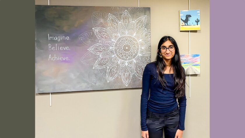 Priya Bavalia, a teen artist from Hillsdale, stands with one of her original paintings on display at the Hillsdale Free Public Library, where she is exhibiting her work throughout August to raise awareness and funds for the Pulmonary Hypertension Association. Courtesy photo.