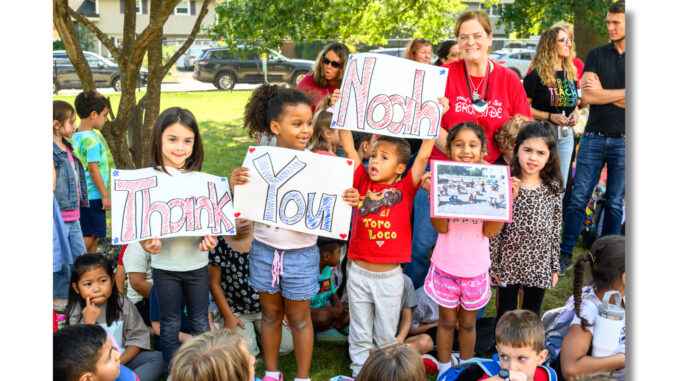 Noah Perez - Brookside feat Brookside school’s student body and PTO turn out on Sept. 12, to cheer Noah Perez’s ribbon cutting for the school’s outdoor classroom and reading area. Perez, who graduated Brookside and is now a Cardinal football player, singer, and actor, told the hundreds gathered, “I’ve always loved reading. To combine that with Scouting—it means a lot to me.” John Snyder photo.