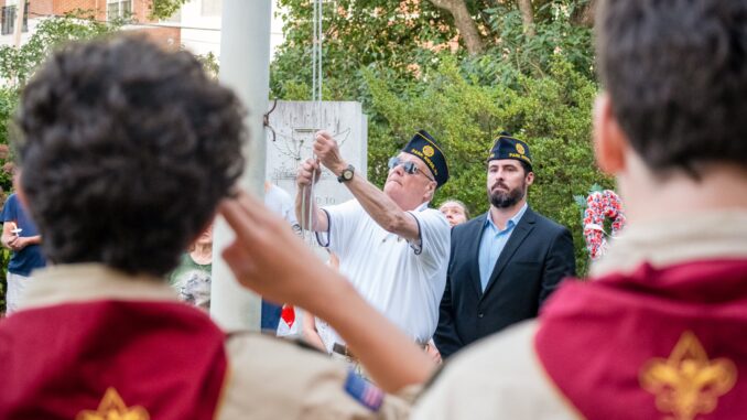 Park RIdge 9-11-25 FB JS Members of American Legion Post 153 raise the American flag as Boy Scouts salute during Park Ridge’s Sept. 11 Memorial Service at Veterans’ Park. John Snyder/Pascack Press