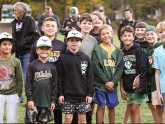Aspiring Hillsdale athletes gather to witness the start of the Memorial Field project, looking forward to playing on new football, baseball and softball fields. Anthony DeRosa photo.