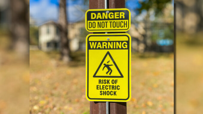 Memorial Field shock warnings feat All 10 light poles at the Township of Washington’s Memorial Field now carry permanent warning signs. Michael Olohan photo.