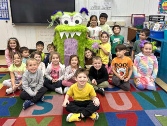 The creation of PSO secretary Kristy O’Connor, monster Gerald (middle of photo, green fur) emerged to help with Trunk of Treat. He’s made a much more meaningful connection in the life of Washington School. Photos by school parent Maureen Colombo.