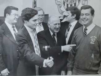 Park Ridge officials are amused and mortified in equal measure as their mayor, Donald F. Gelnaw, sports a Glen Rock football sweatshirt at the Dec. 10, 1980 meeting of the governing body. A good sport, Gelnaw was fulfilling the terms of a wager with that borough’s mayor after the state championship tipped Glen Rock’s way, 22-21. Photo: Thomas Moorhead