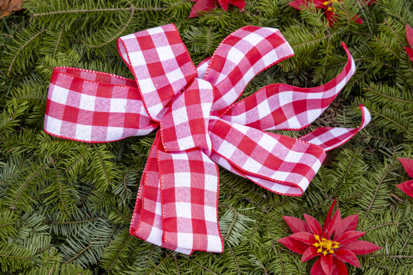 Doris Zaconie decorated the WTFD's Christmas wreaths, for sale at the annual tree sale at Memorial Field. John Snyder photo.