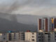 Smoke is seen over buildings after explosions and low-flying aircraft were heard on Jan. 3, 2026 in Caracas, Venezuela. According to some reports, explosions were heard in Caracas and other cities near airports and military bases around 2 a.m. (Photo by Jesus Vargas/Getty Images) via NJMonitor.