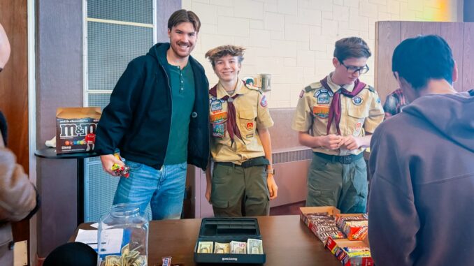 Henry Herzing (center), a Scout with Troop 350, helps run a candy sale fundraiser Feb. 1 at Saint Andrew’s Church in support of his Eagle Scout project, which will assemble “Healing Go Bags” for children and families at Hackensack Meridian Children’s Hospital. Courtesy photo.