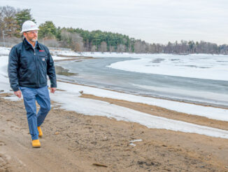 Josh Engelking, Veolia senior director of operations, walks along the banks of the Oradell Reservoir recently. The area is usually underwater. Veolia photo.