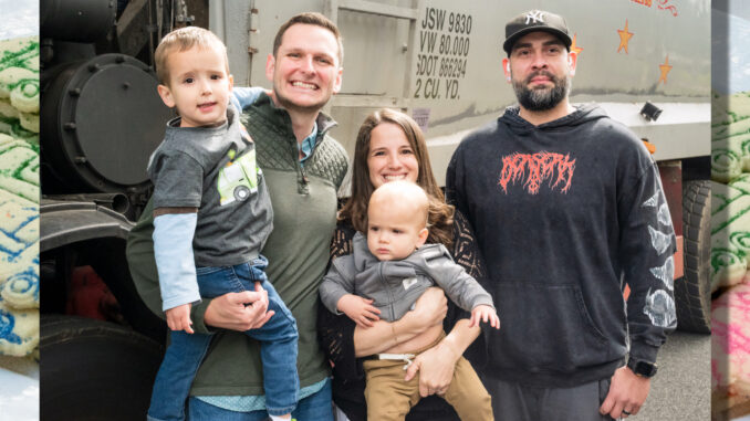 Birthday surprise: River Vale residents Philip and Karina Misklow pose with sons Rocco, left, and Vito alongside Buldo Brothers driver Carlos Gomez during a May 30 birthday surprise for Rocco, whose love of garbage trucks inspired a special visit from the sanitation company. Gomez, who services the neighborhood, volunteered to stop by on his day off with a Buldo Brothers truck. Photo by John Snyder.