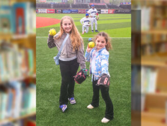 Now pitching for the New York Boulders… Berkeley school sisters Scarlett Hlavaty, a fourth grader, and Madelyn Hlavaty, a first grader, throw out a ceremonial first pitch during the “Rockland Boulders Reading Challenge” celebration at Clover Stadium as their father, Kevin Hlavaty, prepares to catch both balls at once. Courtesy photo
