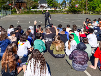 Hillsdale Police Patrol Officer Brianna DeGennaro speaks to students about e-bike and bicycle safety at a May 1 assembly at George G. White Middle School. Photo by Michael Olohan.