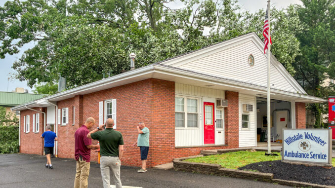 Assessing damage outside the Hillsdale Volunteer Ambulance Service headquarters after a large tree struck the building early Friday morning. Ambulance operations continue from the Hillsdale Fire Department. Boyd A. Loving photo.