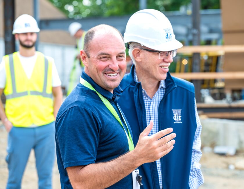 Superintendent Robert Lombardy, left, and project architect Joseph DiCara prepare to add their signatures to a ceremonial steel beam marking a milestone in the renovation and expansion of George G. White Middle School on July 24. John Snyder photo.