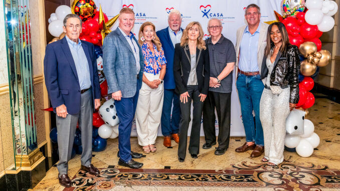 Charles “Chip” Giamo, a longtime Bergen County CASA volunteer whose example inspired Township of Washington resident Nilene Evans to become an Advocate in 2016. Giamo died July 25 at 81. In the group photo, from a 2023 fundraiser, Chip is at left with Bergen CASA Board of Trustees members Michael Edwards, Cathy Skinner, Thomas Ayers, Lucy Rosen, Joseph Preziosi, Marc Blatt and Zone LeSane. Bergen CASA photo.