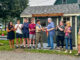 Westwood Troop 350 Eagle Scout Nicholas Doell cuts the ribbon officially opening the borough’s pilot compost program, the culmination of nearly a year and a half of planning and construction. From left are Claudia Gonzales-Doell, Council President Lauren Letizia, Dominick Paniscotti, Nicholas Hawrylczak, William Harrahy, Doell, Mayor Raymond Arroyo, Councilwoman Erin Collins, Councilwoman Beth Dell, and Keith Doell. Joann Paniscotti photo.