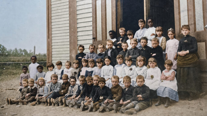 The students of Park Ridge posed for this photograph outside their schoolhouse in the late 1880s. The first Monday of September meant back-to-school time. (Colorized photo)