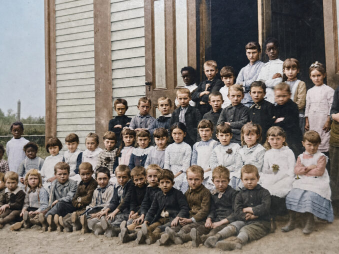 The students of Park Ridge posed for this photograph outside their schoolhouse in the late 1880s. The first Monday of September meant back-to-school time. (Colorized photo)