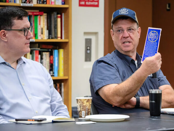 Sean Dargan, left, a financial planner affiliated with Northwestern Mutual in Paramus, listens as Steven Hopper, president of Park Ridge-based Pratt Plumbing Heating & Air Inc., holds up company literature during the Greater Pascack Valley Chamber of Commerce’s August meeting at the Westwood Public Library. Hopper noted that Pratt will mark its 100th anniversary in 2027. John Snyder photo.