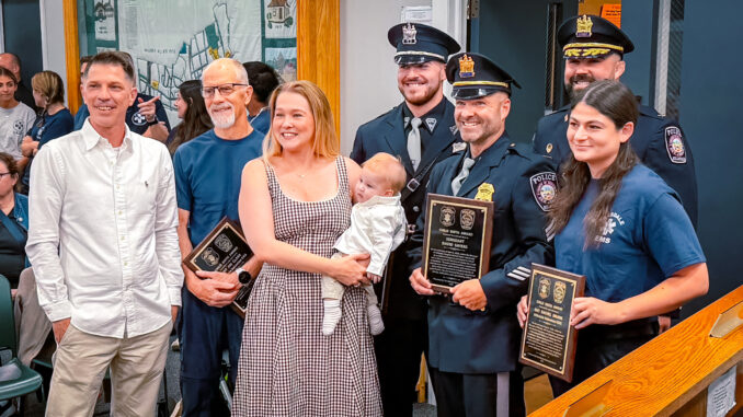A happy reunion at Hillsdale Borough Hall: Parents Alyssa and Joshua Boone, with baby Marshall, join Police Chief Travis Woods, Sgt. David Sayers, Officer Dominick Speciale and EMTs Jim Clark and Rachel Brunn as the borough honors the responders who helped deliver Marshall at home April 6. Anthony DeRosa photo.