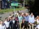 Rosemarie D’Alessandro, center in a butterfly-patterned dress, gathers with officials, friends and supporters beneath the newly unveiled “Joan’s Joy Legacy Lane” sign Sept. 7. The dedication, held on her daughter Joan’s birthday, honors the foundation Rosemarie built in her memory and its work for child safety. Anthony DeRosa photo.