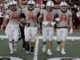 #4 Chase McDowell celebrates after his first varsity touchdown. Above: #52 Hudson Mahon, #74 Isaac Hsiao, #61 Luka Pinto, and #54 Mason Hennessy take the field as captains for the coin toss. Photo by Owen Baskin.