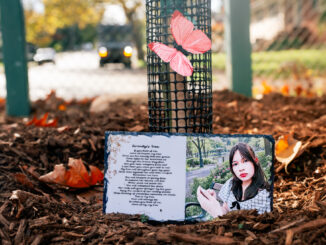 A portrait of Serenity Lynn rests beside the poem “Serenity’s Tree” at the foot of the magnolia planted in her memory at Brookside Park. The tree was dedicated Oct. 17 during Westwood’s first Autumn Arbor Fest. Photo by John Snyder.