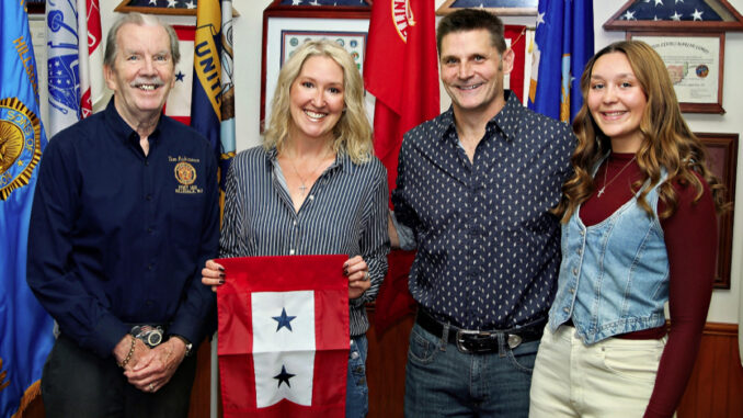 American Legion Post 162 Commander Tom Robinson, from left, presents a two-star Blue Star Service Flag to Shane Svorec, joined by husband Rich and daughter Lainey. The stars honor the Hillsdale couple’s two daughters serving in the U.S. military: Pfc. Destiny Svorec, left, an Army horizontal construction engineer, and AG3 Lainey Svorec, right, a Navy reservist and aerographer’s mate third class. The presentation was made at the post’s Oct. 3 meeting. Zoltán Horváth photo.