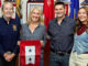 American Legion Post 162 Commander Tom Robinson, from left, presents a two-star Blue Star Service Flag to Shane Svorec, joined by husband Rich and daughter Lainey. The stars honor the Hillsdale couple’s two daughters serving in the U.S. military: Pfc. Destiny Svorec, left, an Army horizontal construction engineer, and AG3 Lainey Svorec, right, a Navy reservist and aerographer’s mate third class. The presentation was made at the post’s Oct. 3 meeting. Zoltán Horváth photo.